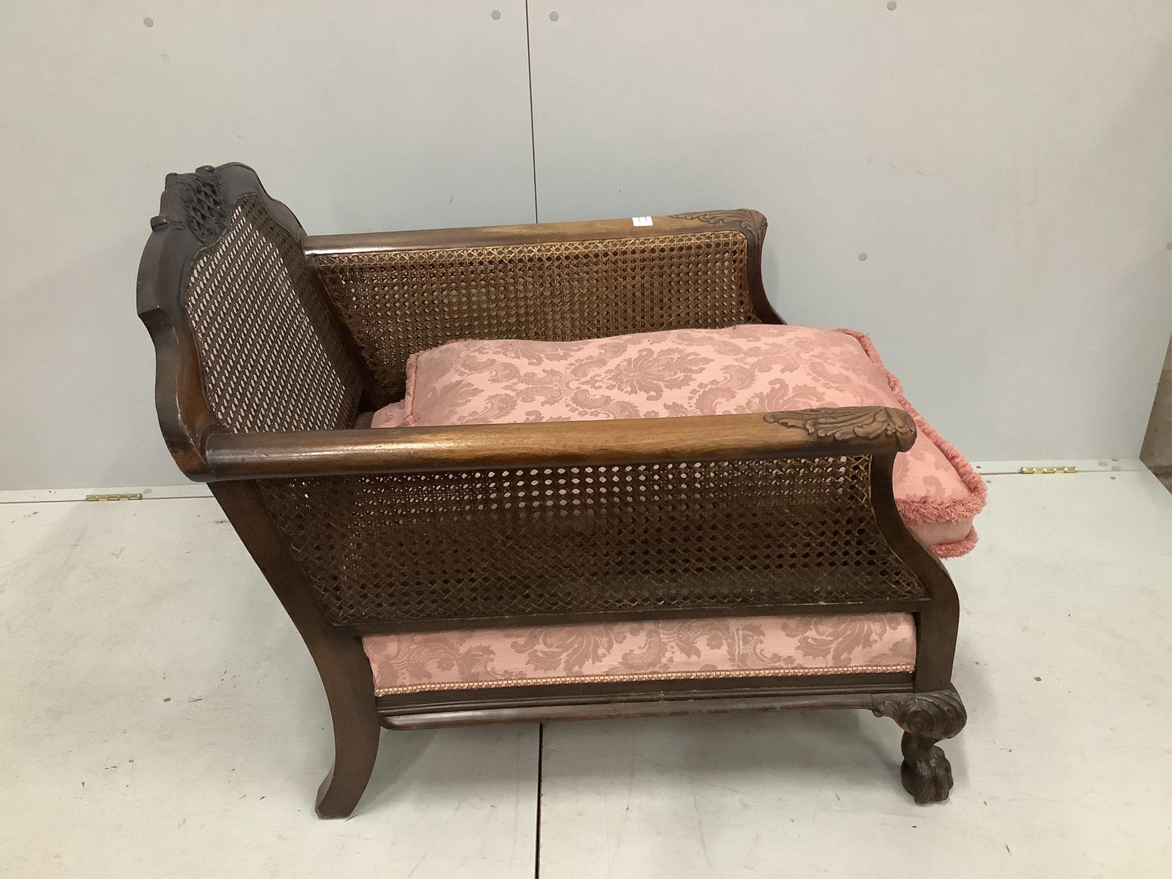 A 1930's mahogany three piece Bergere suite, with double caned arms and single caned backs. Condition - some fading with small damages to the caning